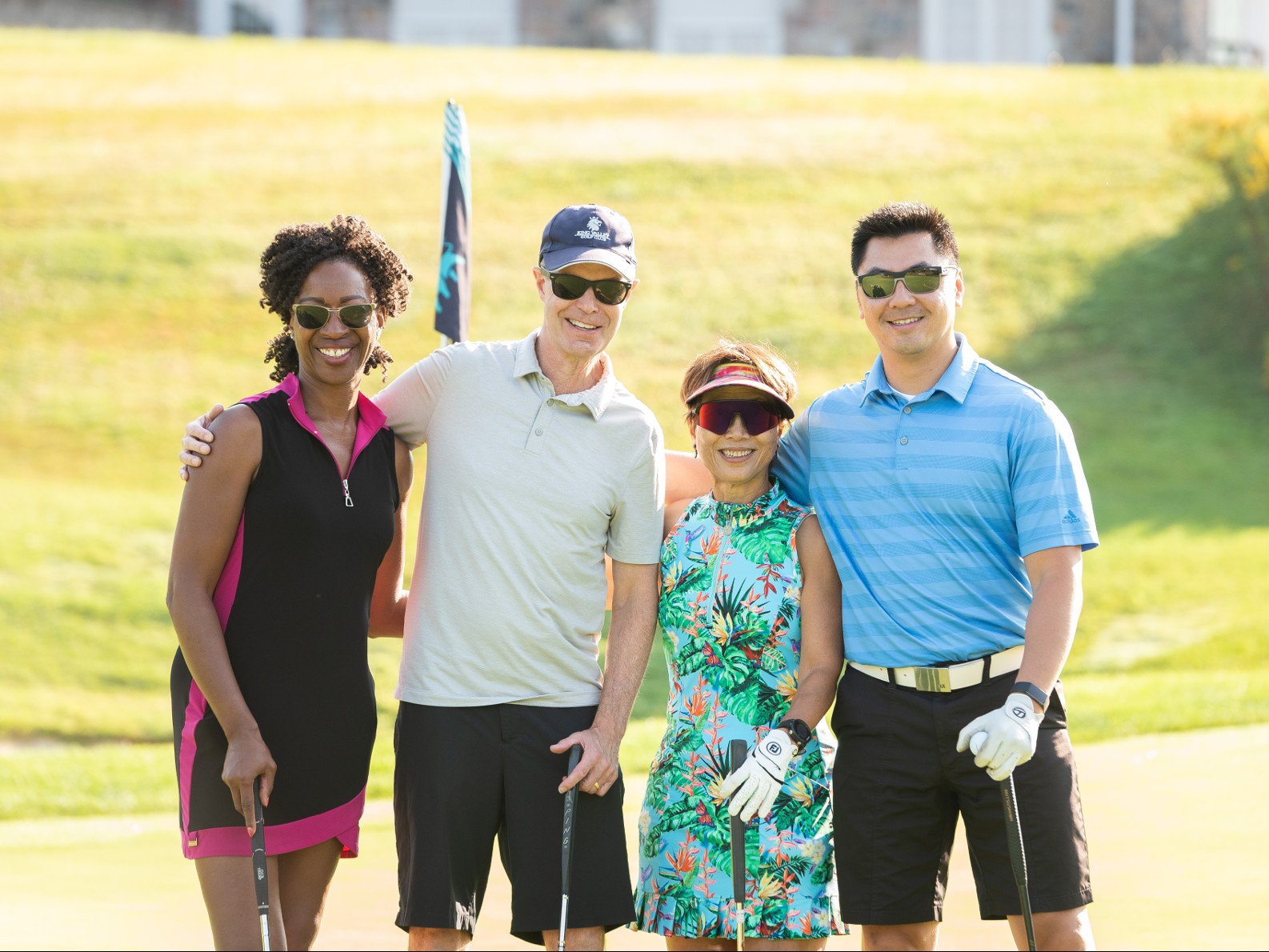  Bridget Paton, Barry Litman, Dr. Amy Wong and Hung Dao standing together with a golf club