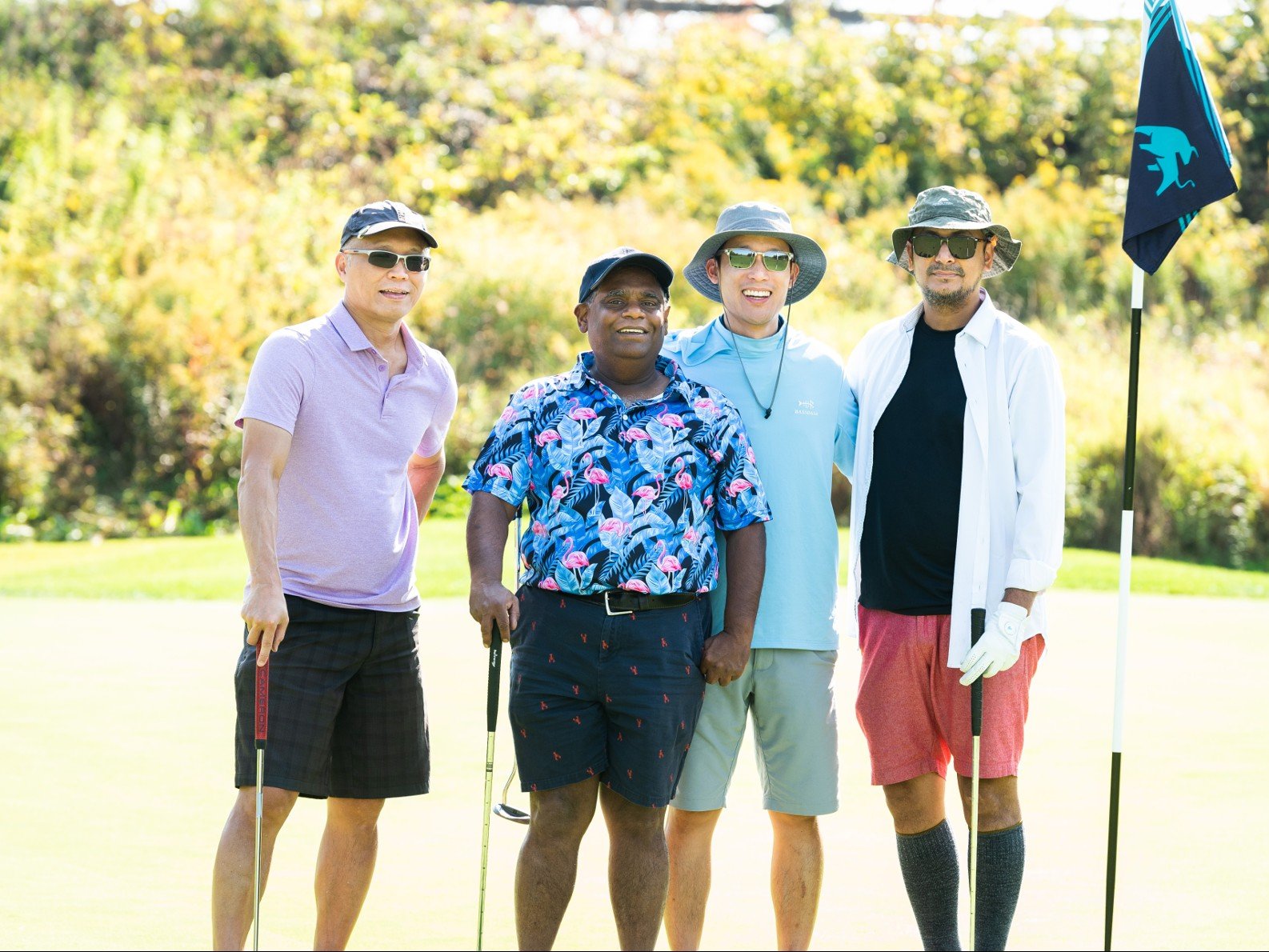 Dr. Allan Yee, Dr. Partha Datta, Dr. James Jeong and Dr. Vishnu Singh pose at a hole on a golf course