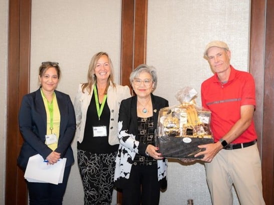 Dr. Sharon Bal, OMF board director and OMA vice-chair; Janet Lambert, OMF vice-chair, MPP Daisy Wai presenting winner John Dickie with the door prize 